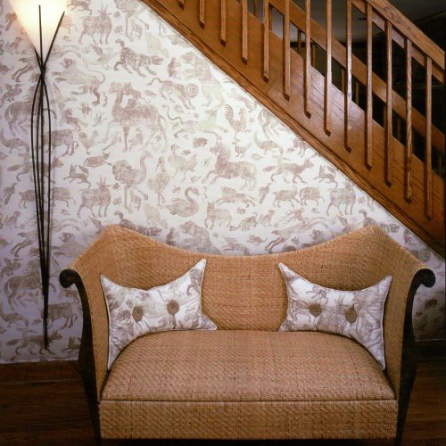 wicker bench in front of midcentury modern staircase